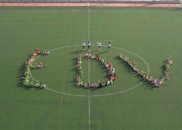 Niños y niñas formando las letras E D V en el campo de fútbol de la UJA